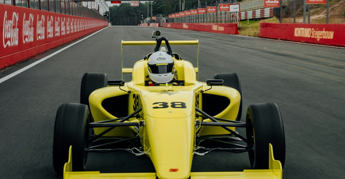 yellow and black f 1 car on road during daytime