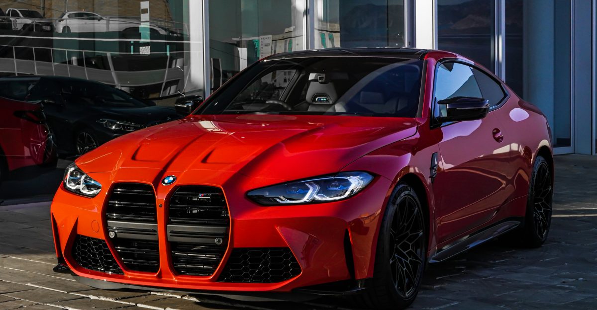 red bmw m 3 coupe parked on gray concrete pavement during daytime
