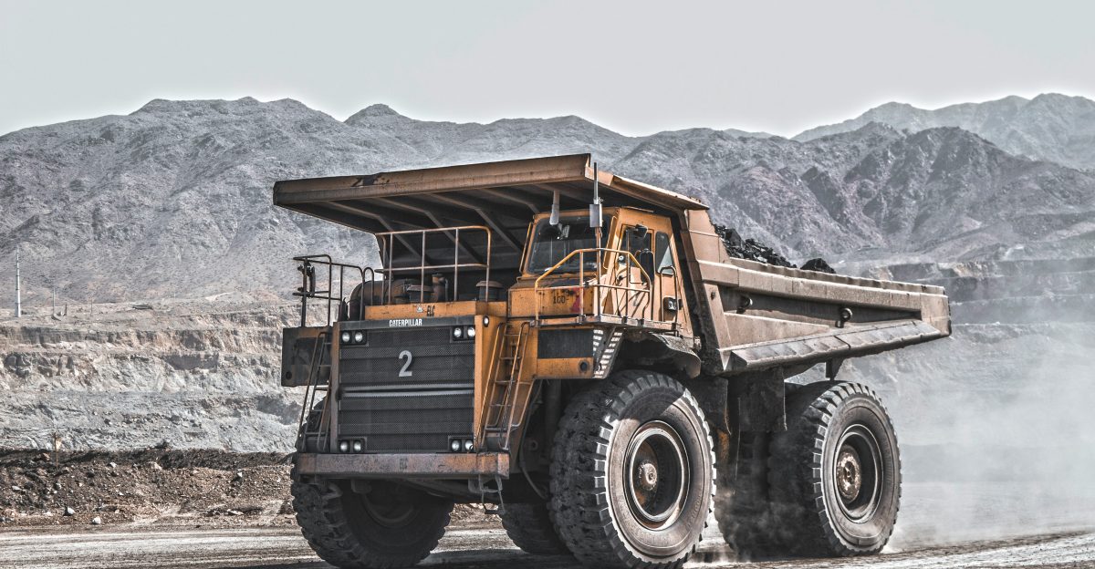 yellow and black heavy equipment on snow covered ground during daytime