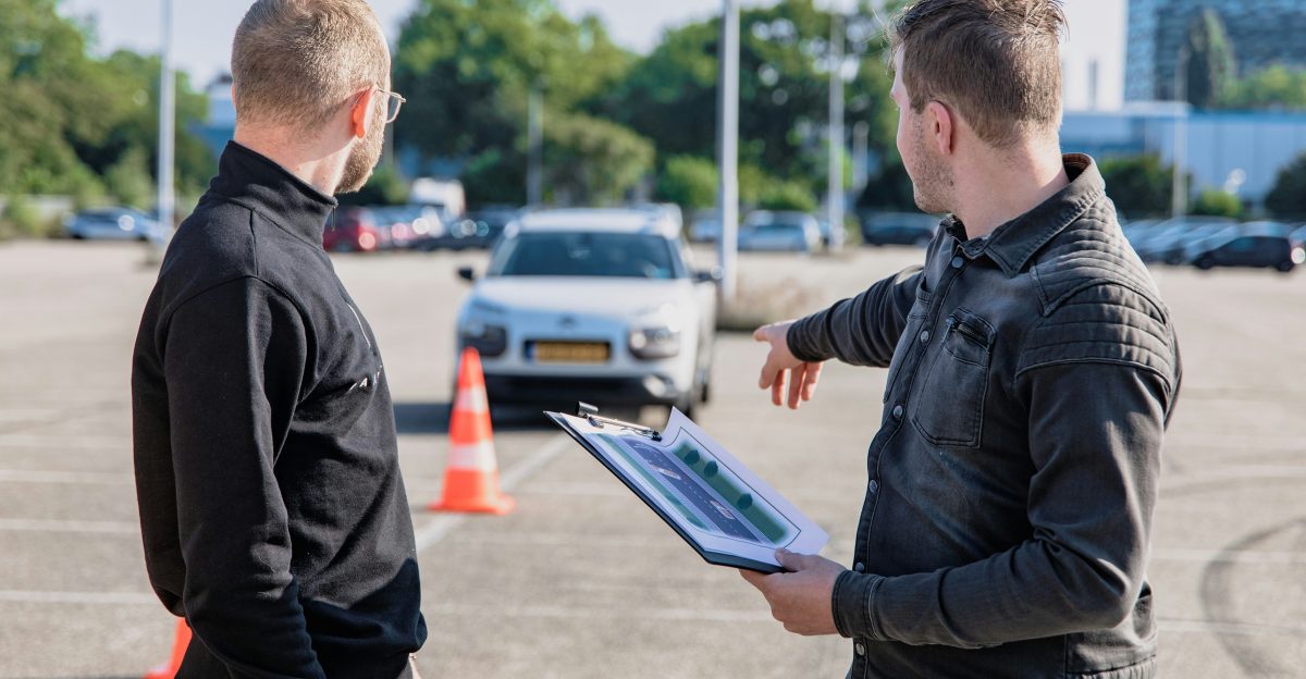 man in black jacket holding blue tablet computer