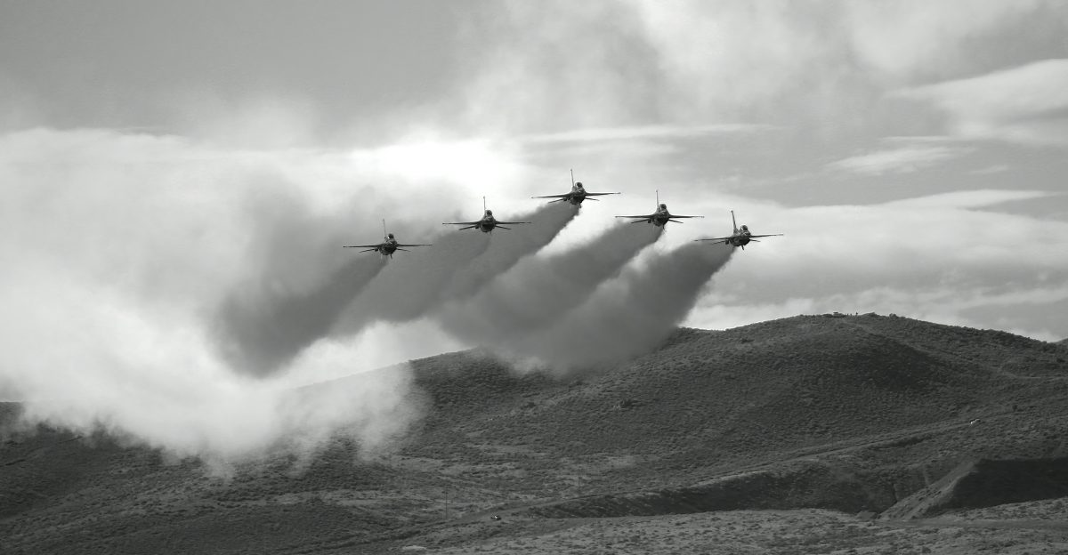 a group of planes flying in formation in the sky