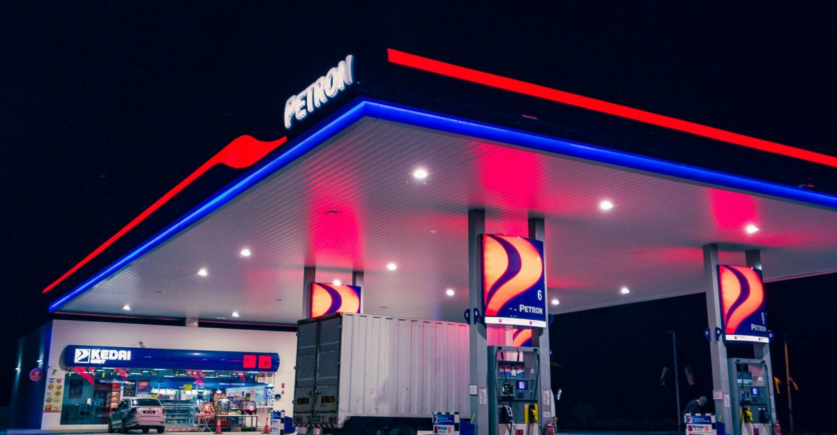 a gas station lit up with red white and blue lights