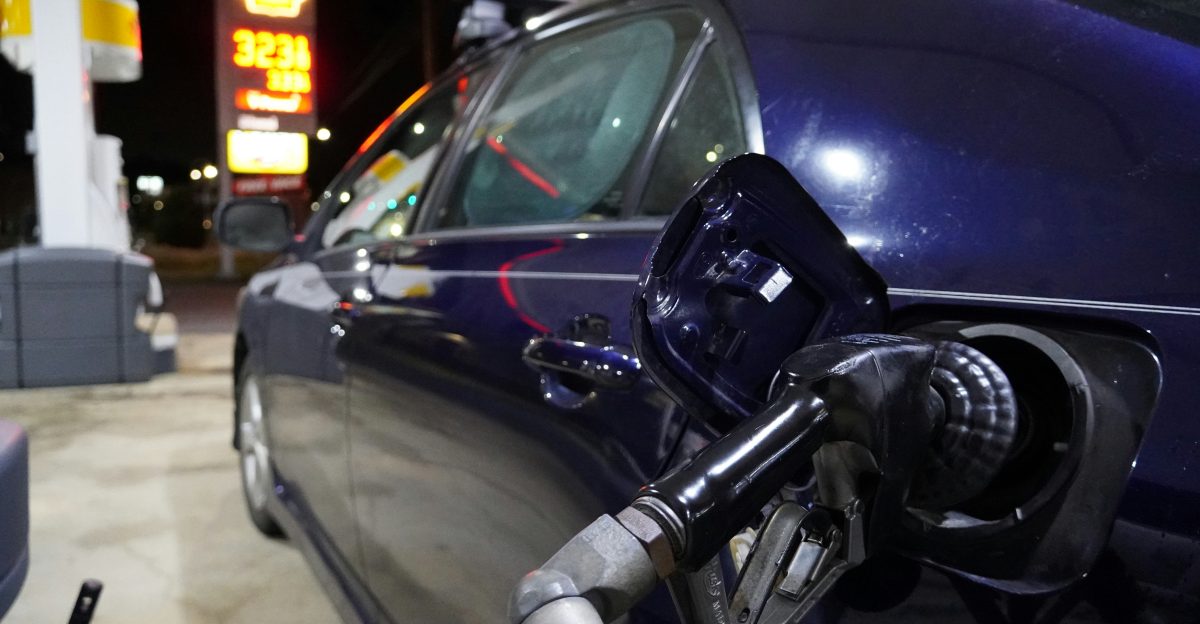 a blue car is parked at a gas station