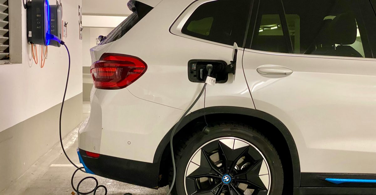 an electric car plugged in to a charging station
