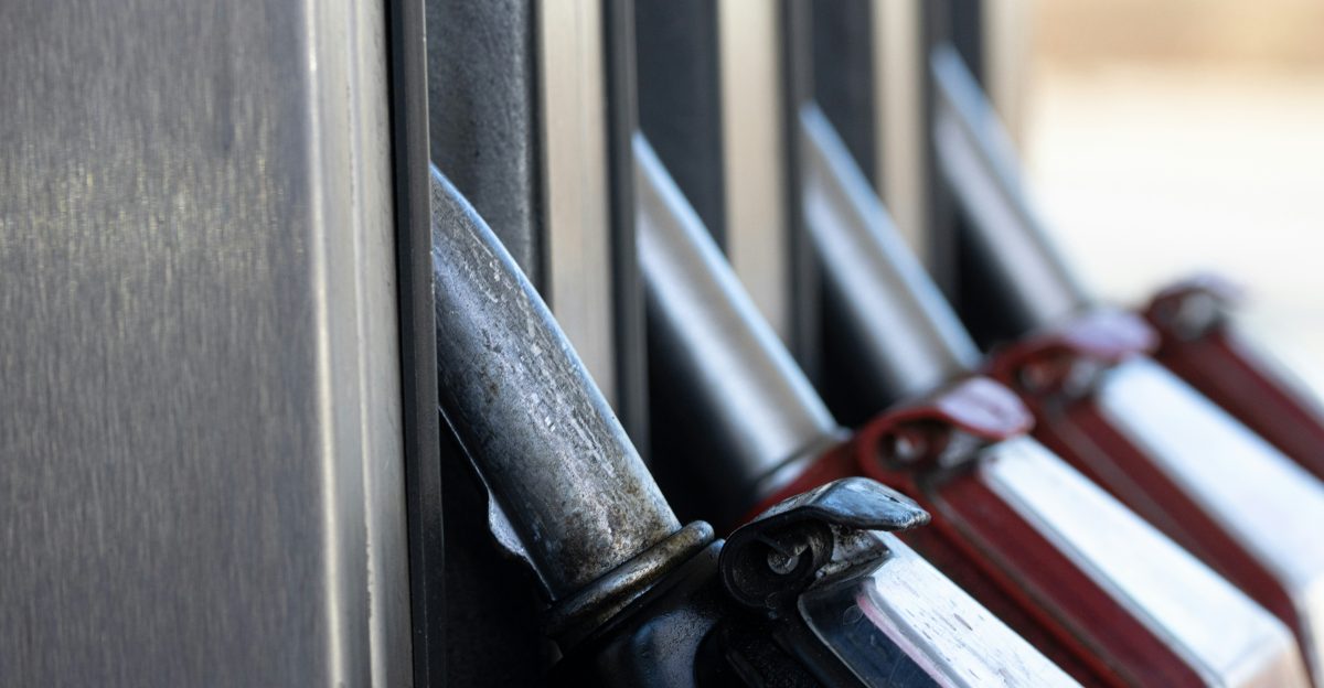 a row of knives hanging on the side of a building