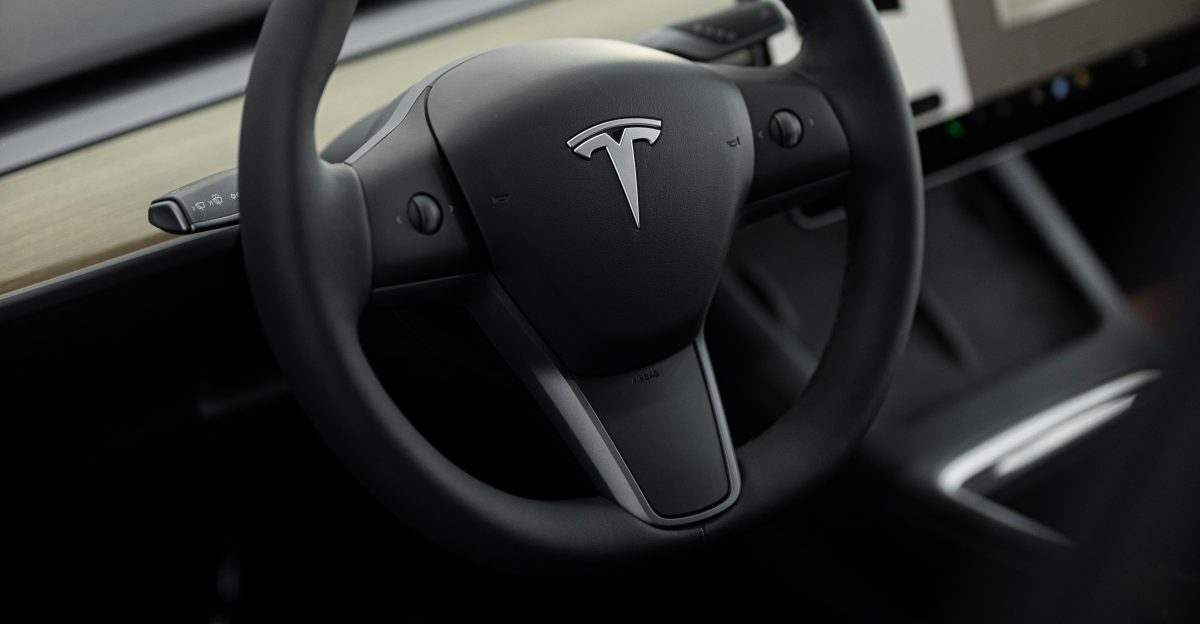a car dashboard with a steering wheel and a display screen