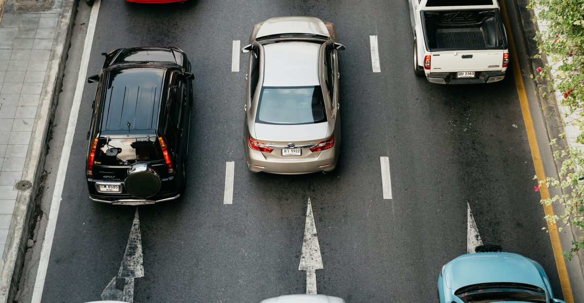 A group of cars on a road photo - Free Grey Image on Unsplash
