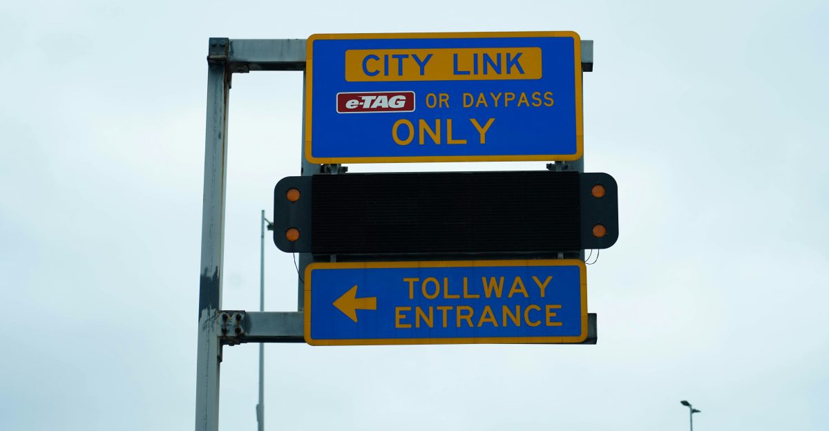 a blue and yellow street sign with a sky background