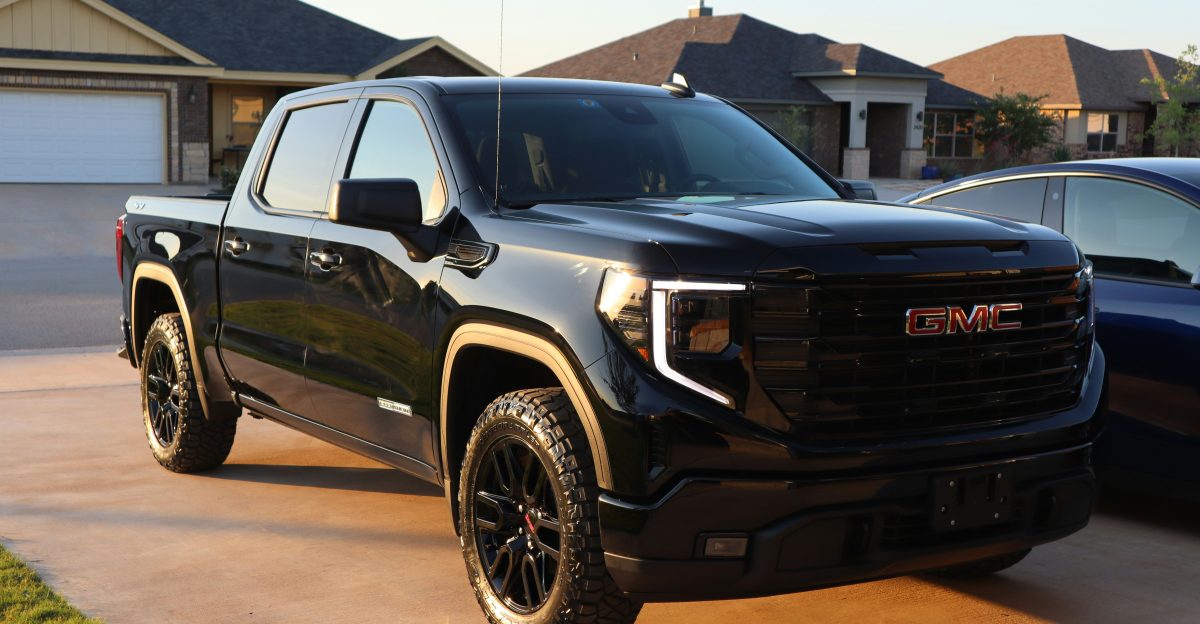 a black truck parked in a driveway