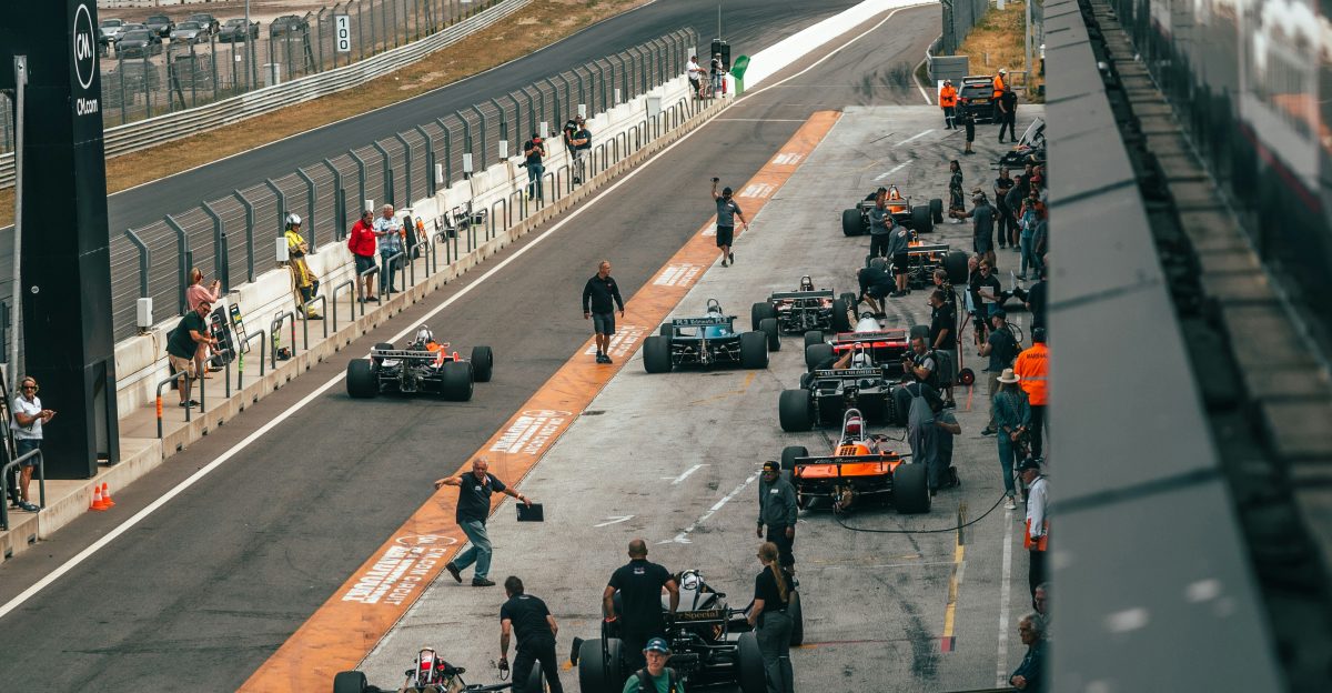 a group of people around a race car on a track