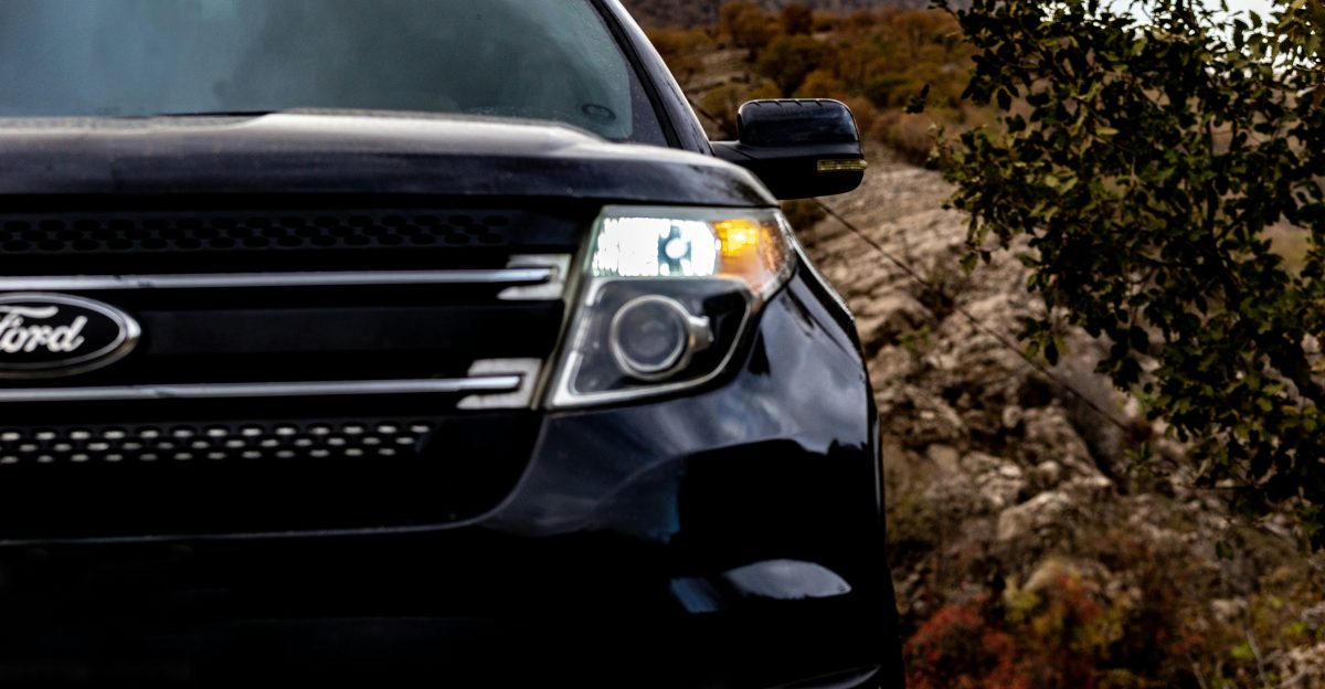 a black car on a dirt road