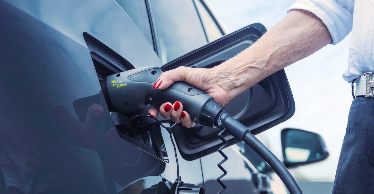 a person pumping gas into a car at a gas station