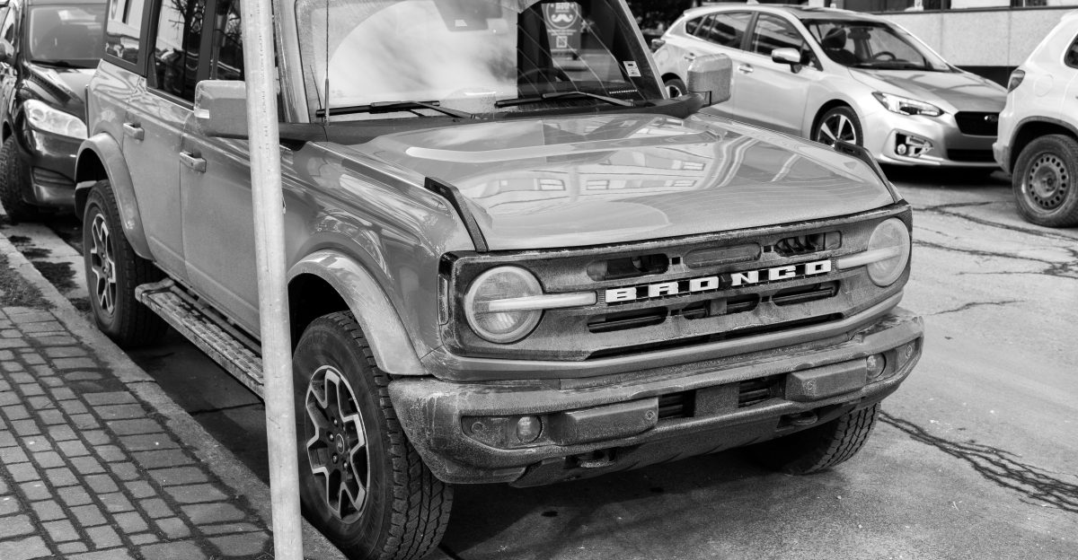 a black and white photo of a truck parked on the side of the road