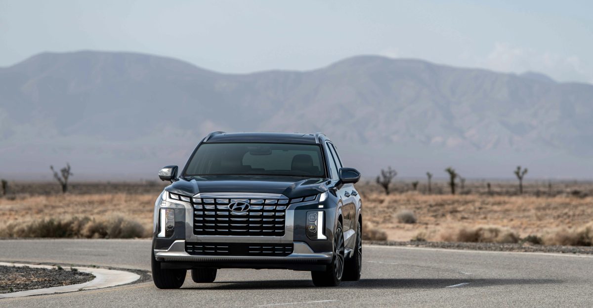 a black car driving down a curvy road