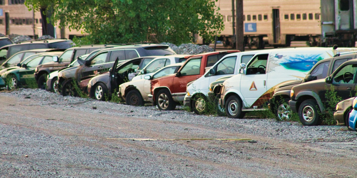 a row of parked cars sitting next to each other