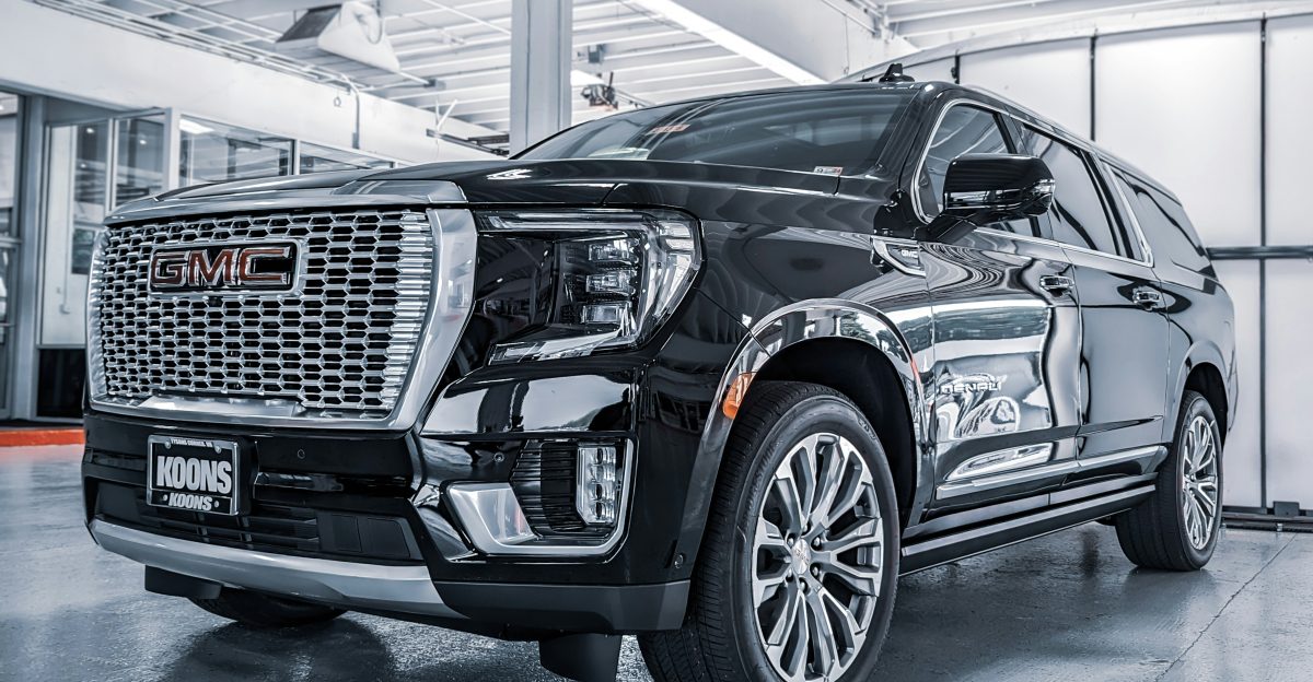a black suv is parked in a garage
