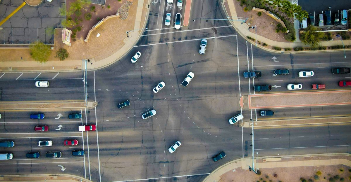 an aerial view of a street intersection with cars