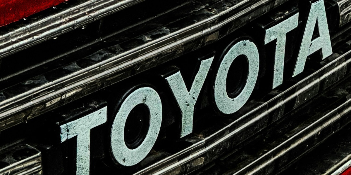 a close up of a toyota logo on a red car