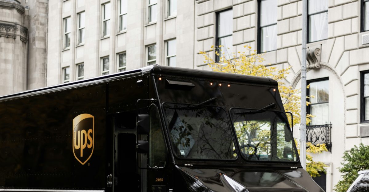 a ups truck driving down a city street