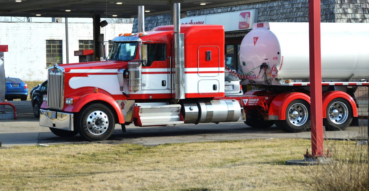 a red and white truck parked in a parking lot