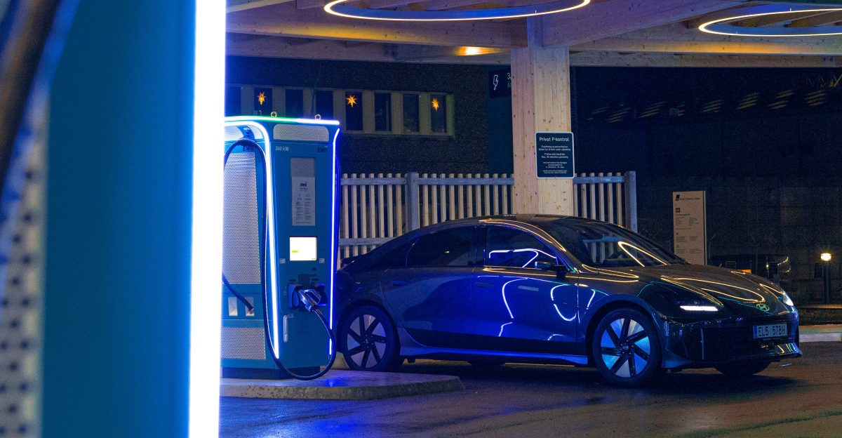 a blue car is parked at a gas station