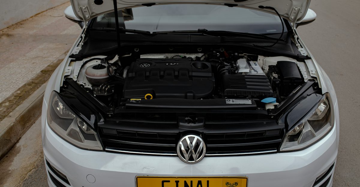 a white volkswagen car with its hood open