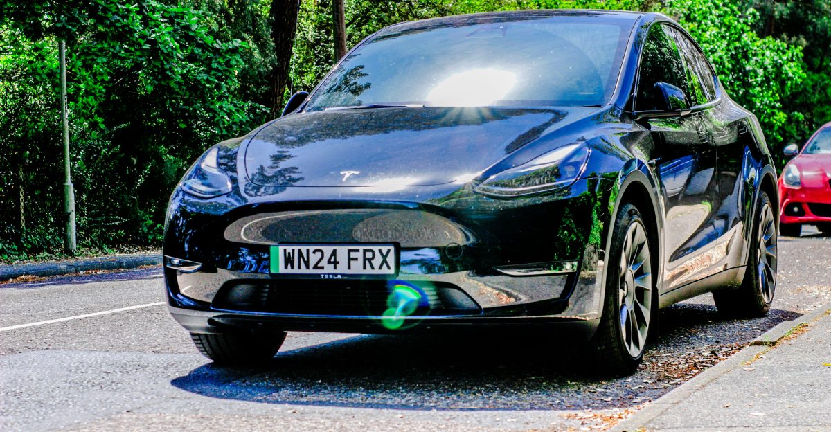 Two cars are parked on the side of the road