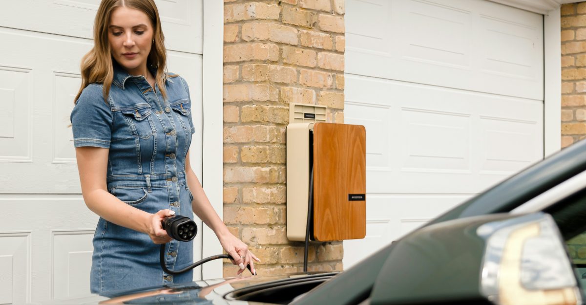 A woman is standing next to a car
