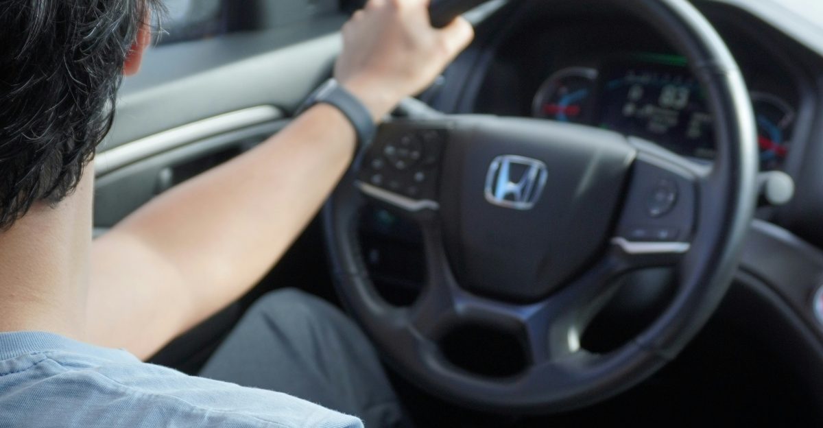 A man driving a car down a street