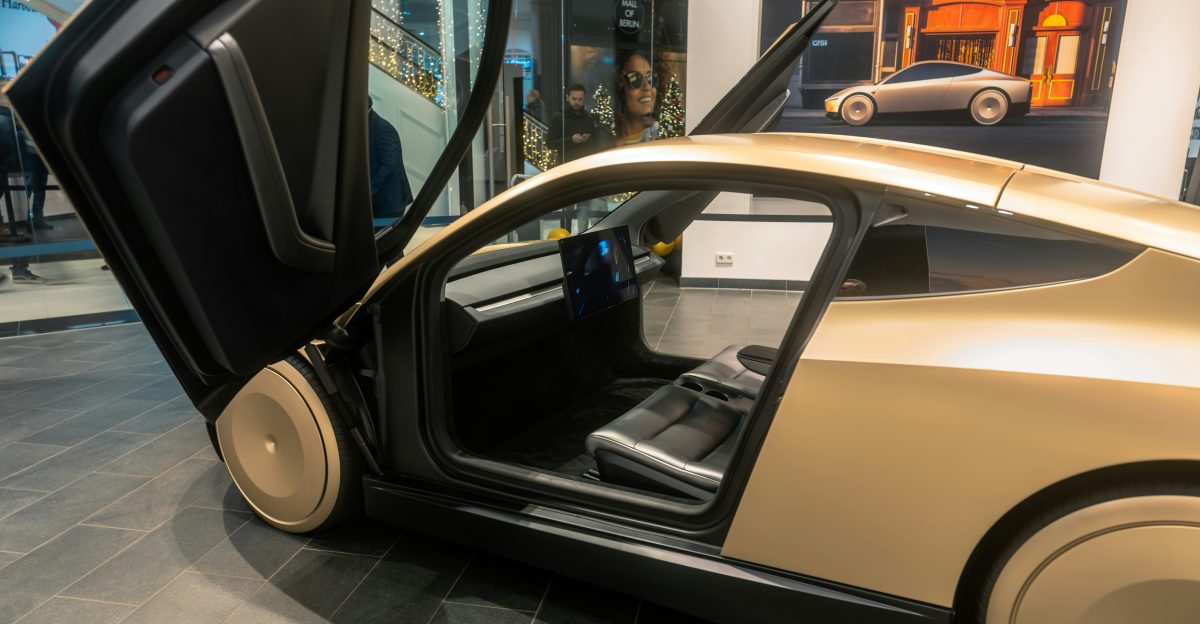 A car with its door open on display in a museum
