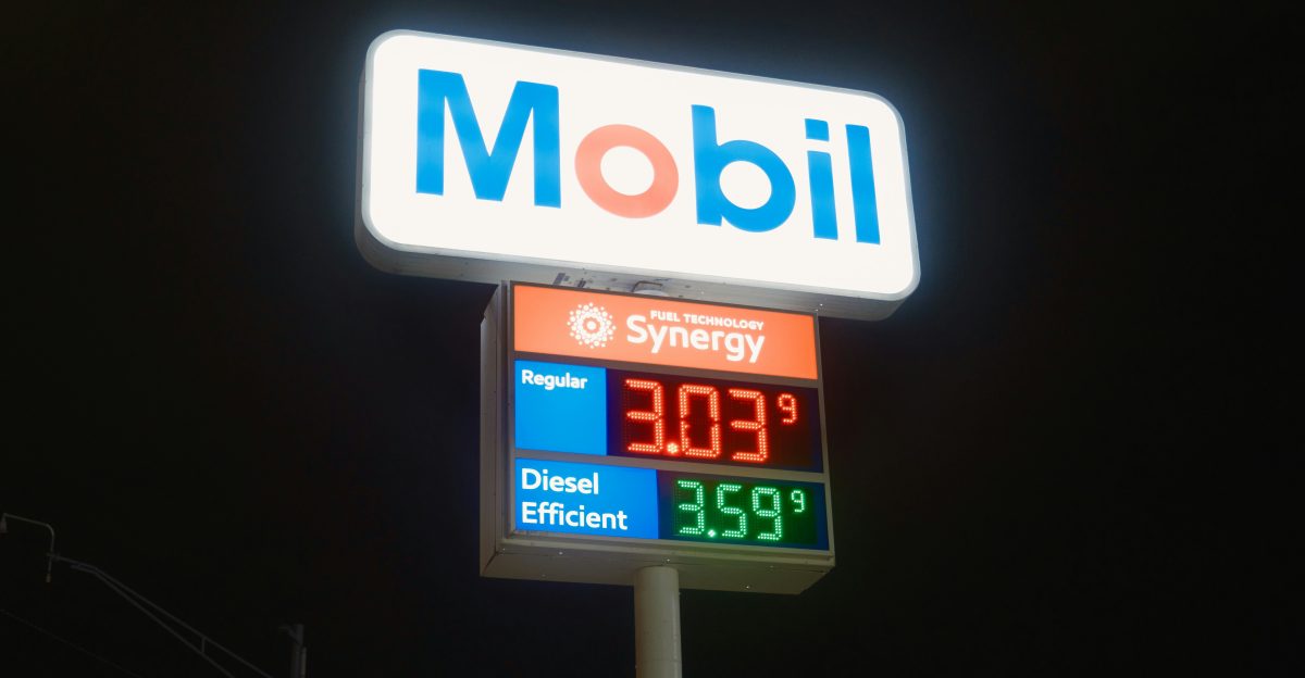 Mobil gas station sign with fuel prices at night