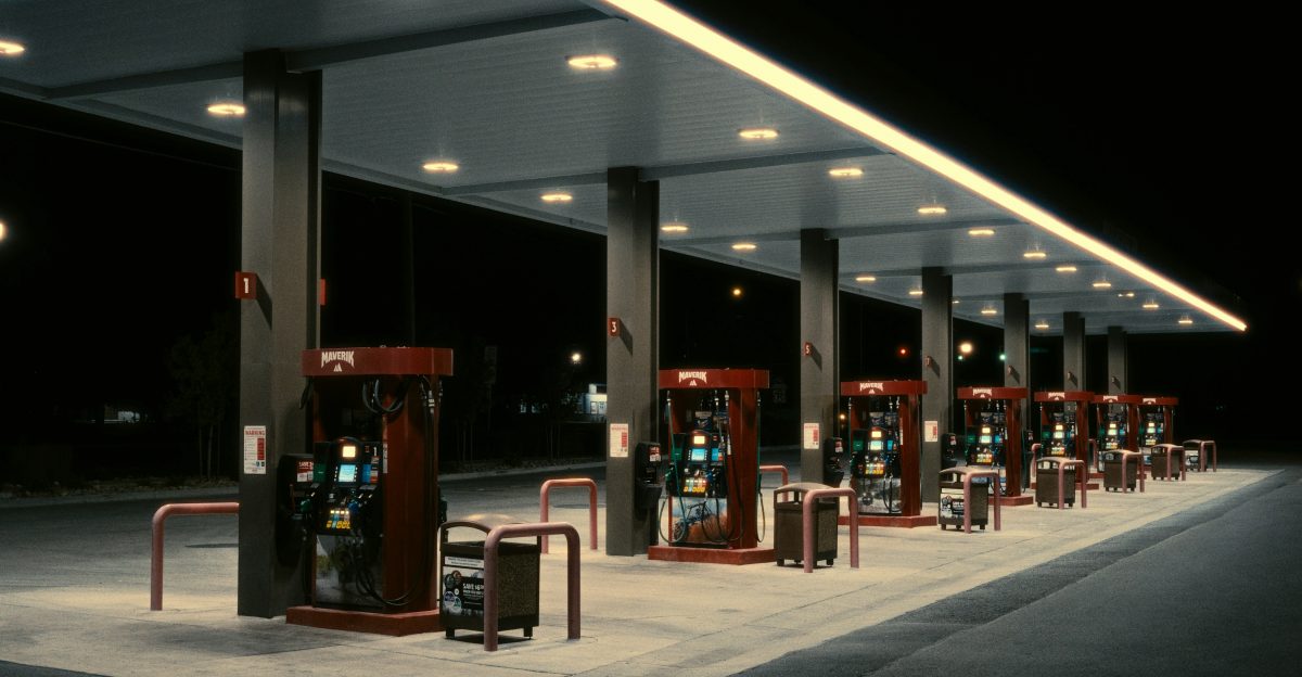 Row of illuminated gas pumps at night