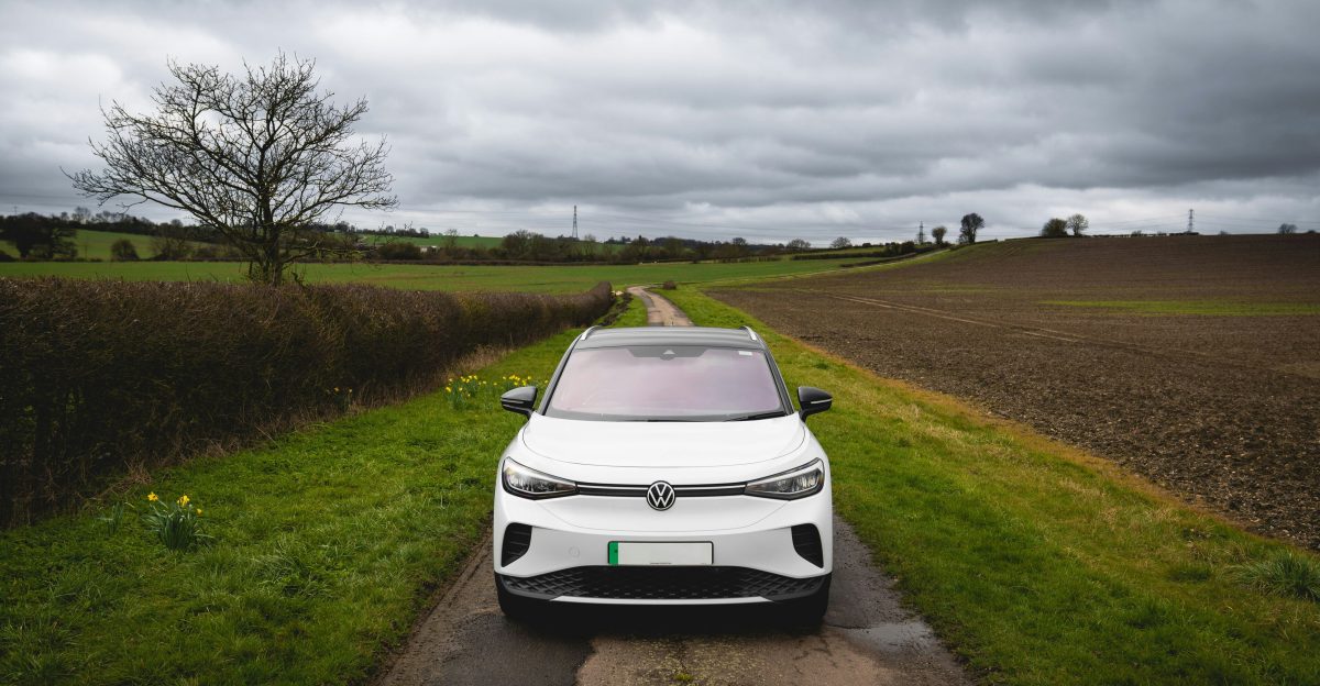 White electric car parked on a rural road
