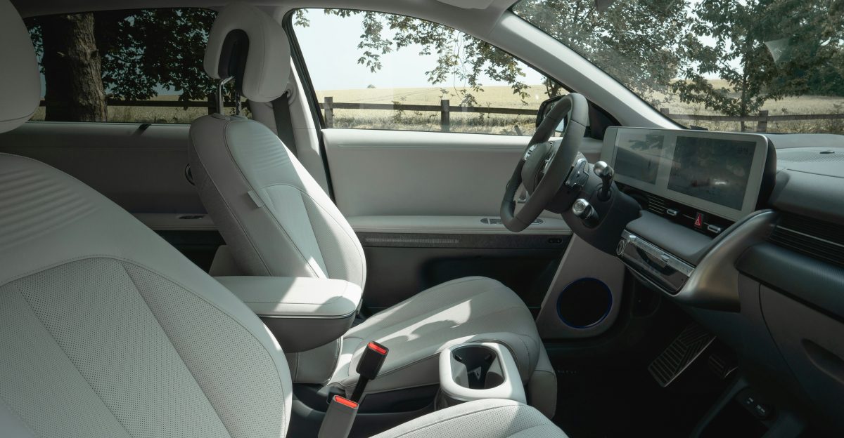 Interior view of a modern car with white seats