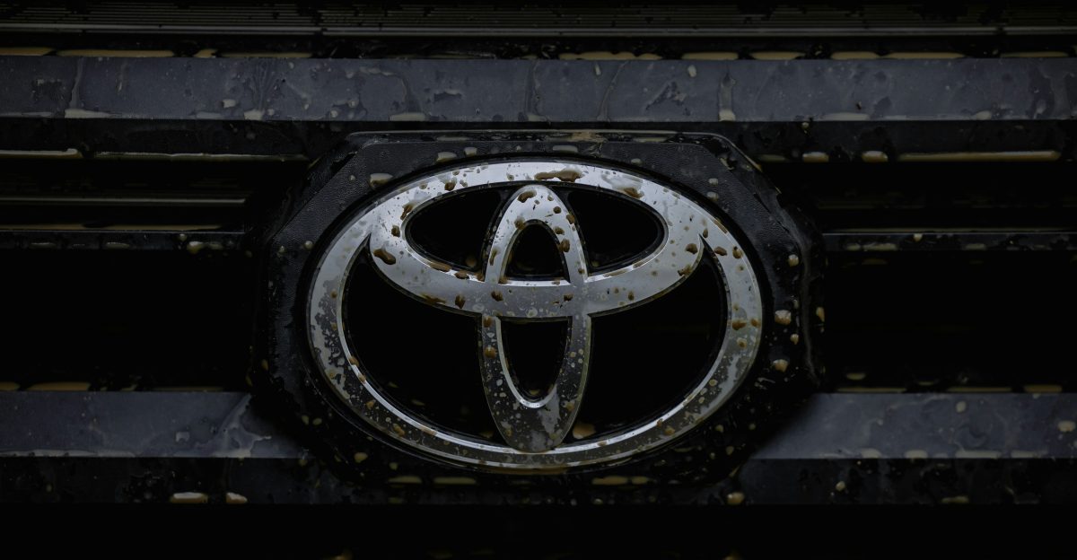 Close up of a dirty toyota car emblem on grille