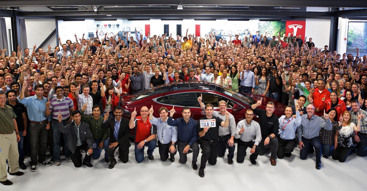 Tesla HQ Salute With one finger up for the first Model S delivery VIN 0001 at the Deer Creek HQ Driving inside is OK for an EV Licence plate TSLA S1 Tesla Model S VIN 1 belonging to Steve Jurvetson