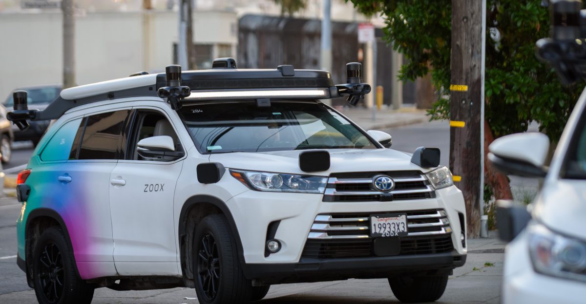A Toyota Highlander modified for use as an autonomous vehicle testbed by self-driving car company Zoox is pulls into a gas station in San Francisco