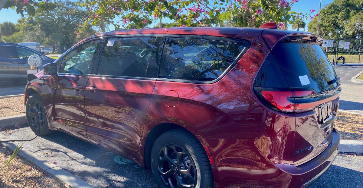 Chrysler Pacifica Hybrid RU minivan finished in Velvet Red Pearl Coat being charged
