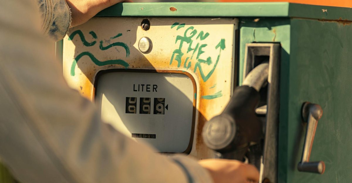 Close-up view of a vintage gas pump with graffiti in bright sunlight
