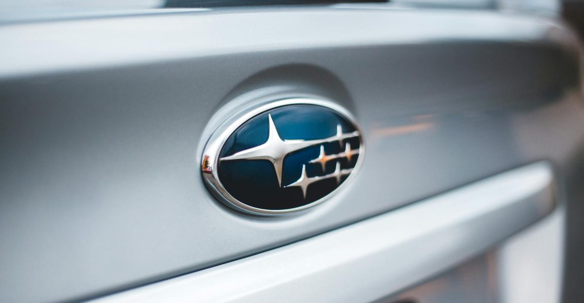 Detailed image of a Subaru emblem on a silver car showcasing design and branding