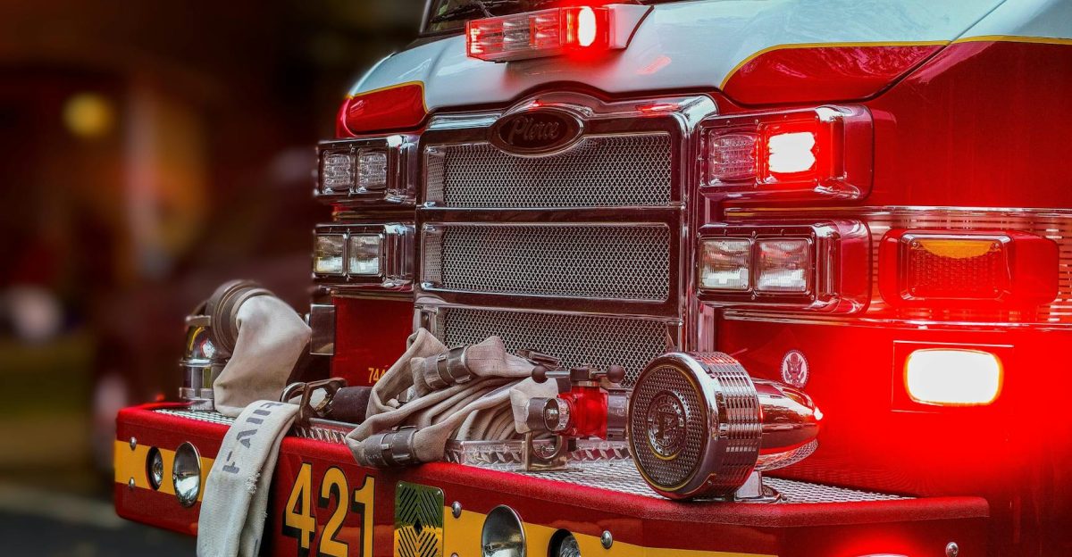 A detailed view of a fire truck bumper with hoses and equipment showcasing emergency vehicle features