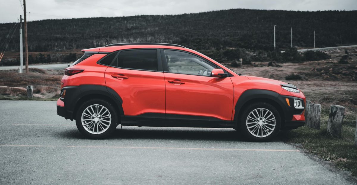 Red SUV parked outdoors on a cloudy day showcasing sleek design and vibrant color
