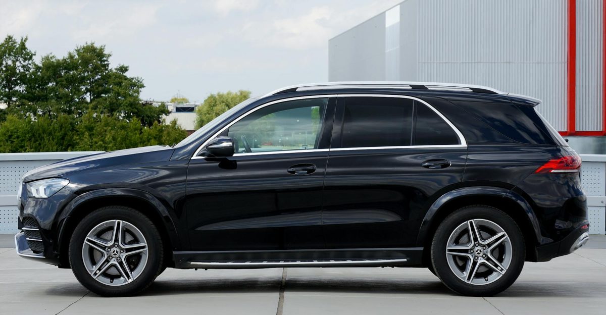A sleek black Mercedes-Benz GLE SUV parked outdoors in a contemporary urban environment