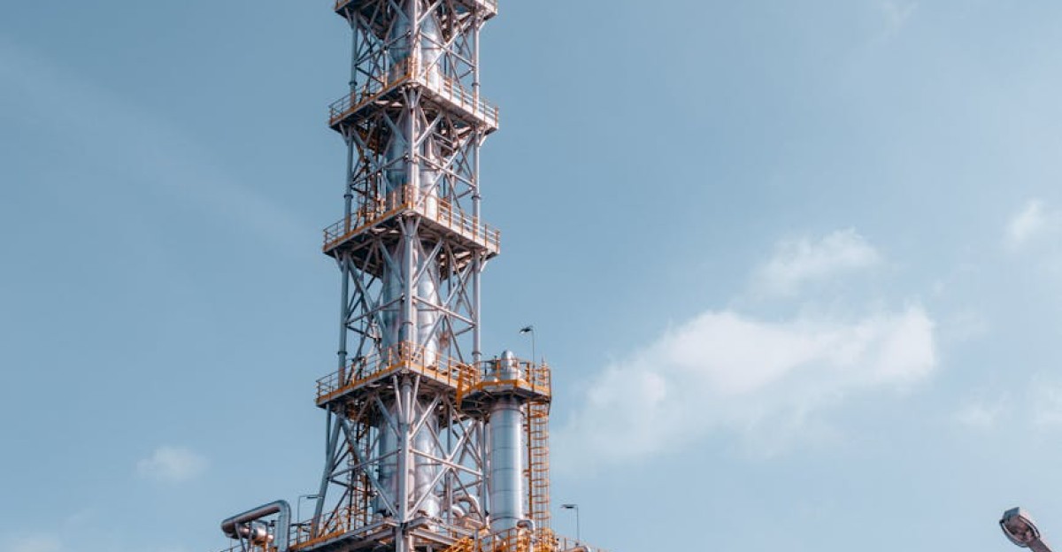 Oil refinery tower against a blue sky in Trzebinia Poland showcasing industrial architecture