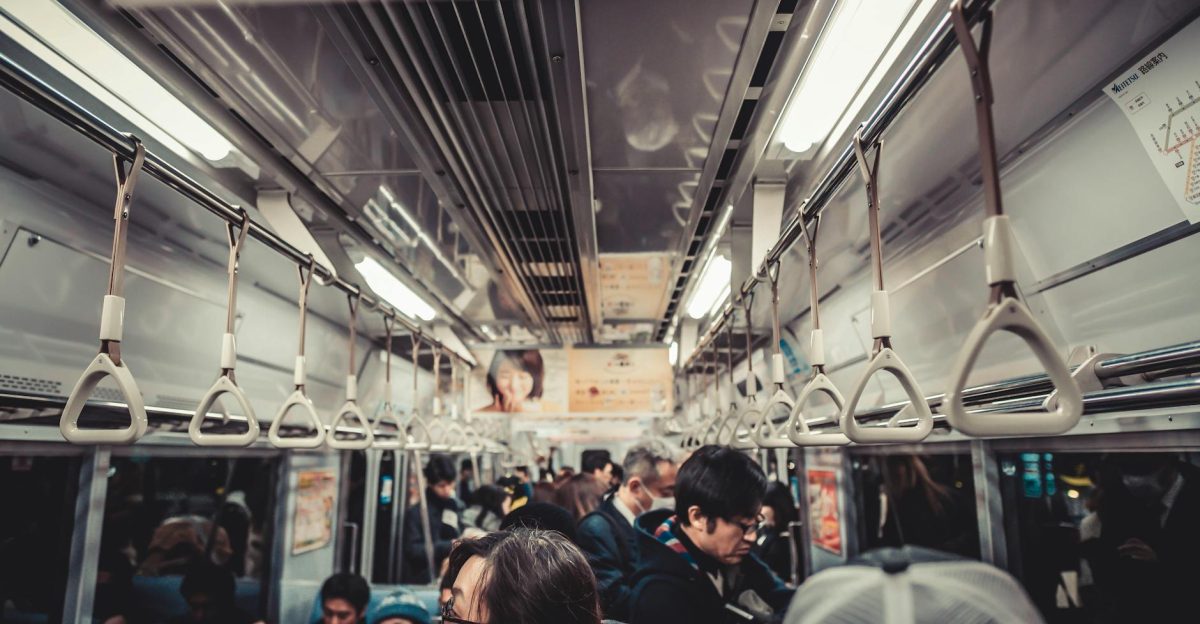 Passengers commuting inside a crowded train showcasing urban public transportation dynamics