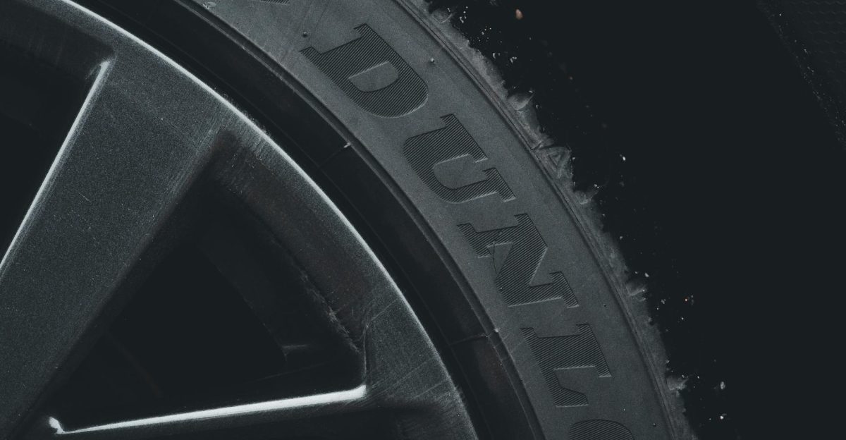 Detailed close-up of a Dunlop tire and rim showcasing its texture and brand text