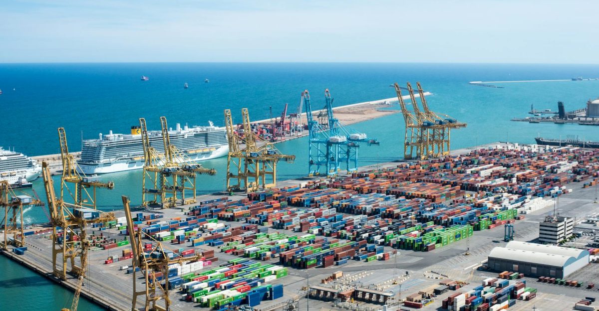 A vibrant aerial shot of Barcelona port featuring cranes containers and cruise ships on a sunny day