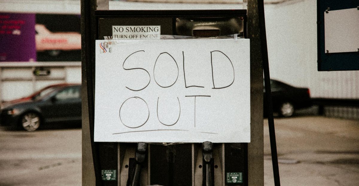 A gas pump at an urban station displaying a Sold Out sign illustrating fuel shortage