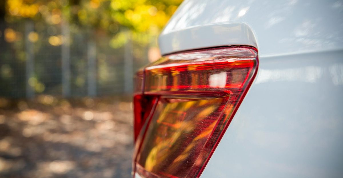 Close-up shot of a modern car s rear light with a blurred autumn background showcasing sleek design
