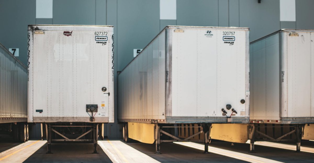 A row of freight trailers parked at a commercial loading dock emphasizing transportation and logistics
